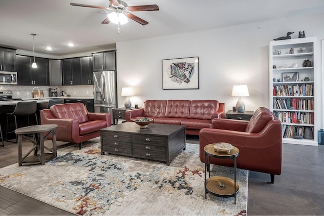 living room featuring ceiling fan, dark hardwood / wood-style flooring, and sink