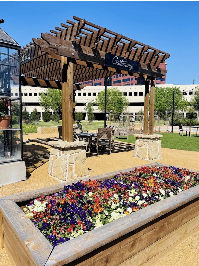 view of community with a pergola and a patio