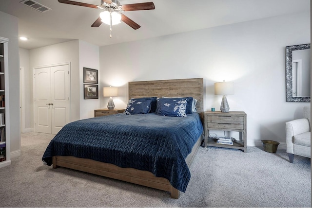 carpeted bedroom featuring a closet and ceiling fan