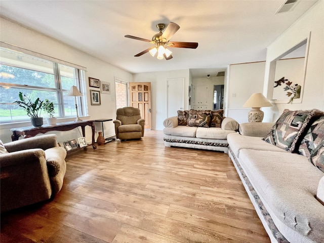 living room featuring ceiling fan and wood-type flooring