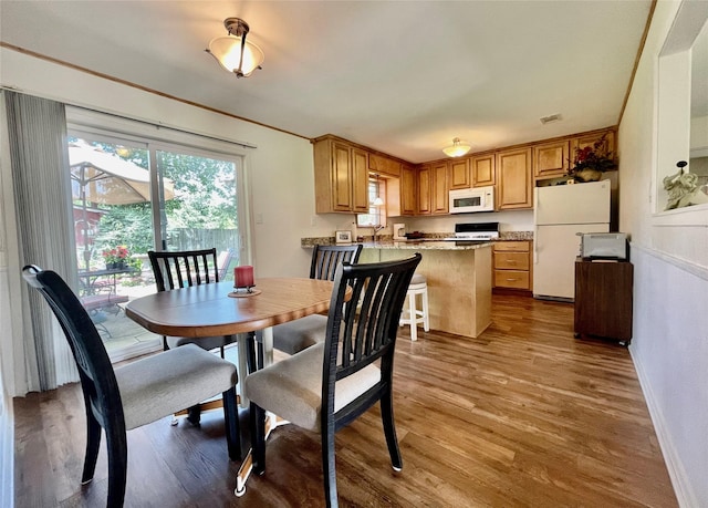 dining area featuring sink and hardwood / wood-style floors