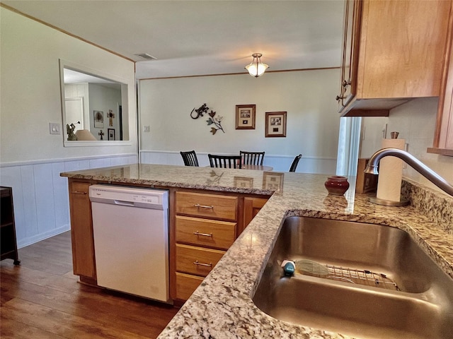 kitchen featuring light stone countertops, dark hardwood / wood-style flooring, white dishwasher, and sink