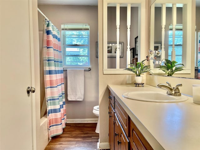 full bathroom with toilet, shower / tub combo, hardwood / wood-style flooring, and vanity