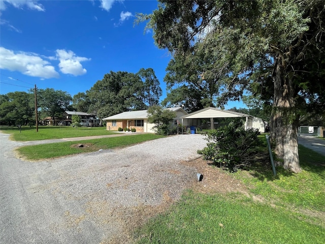 ranch-style home with a front lawn and a carport