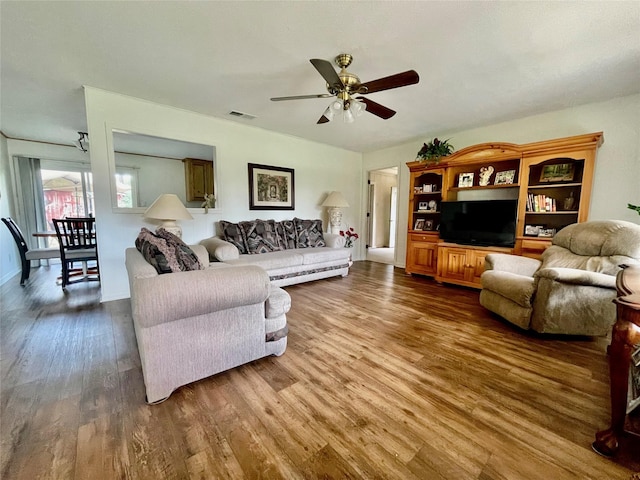 living room featuring ceiling fan and hardwood / wood-style flooring