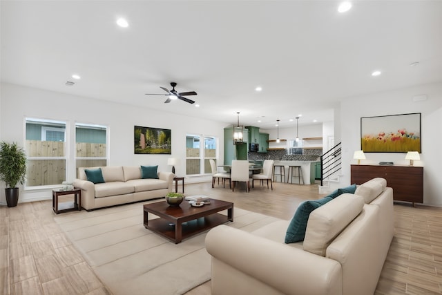 living room featuring ceiling fan and light hardwood / wood-style floors