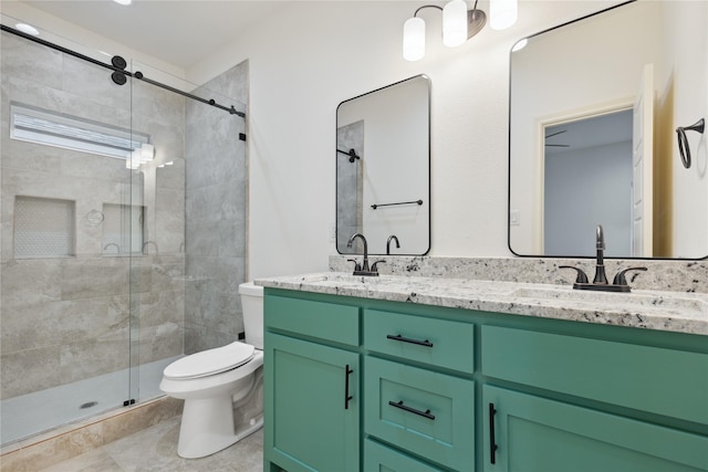 bathroom with vanity, a shower with door, and toilet