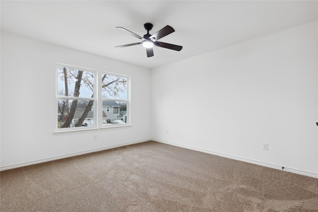 empty room featuring carpet floors and ceiling fan