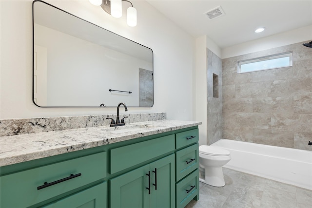 full bathroom with vanity, tiled shower / bath combo, and toilet