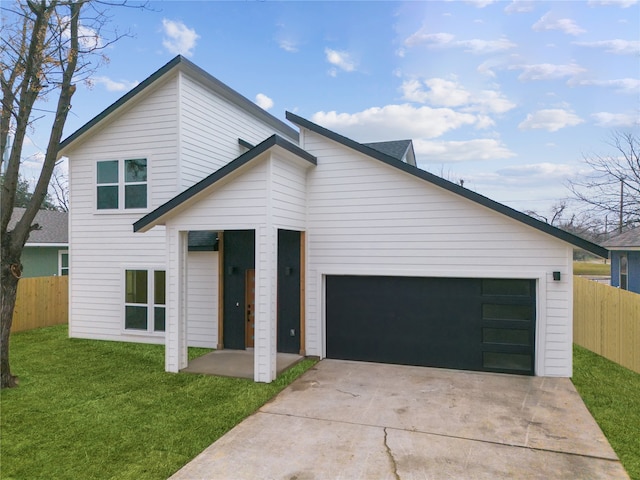 view of front of property featuring a front lawn and a garage