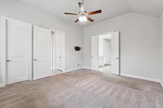 unfurnished bedroom with lofted ceiling, light colored carpet, and ceiling fan