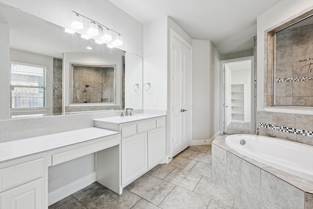 bathroom featuring vanity and tiled tub