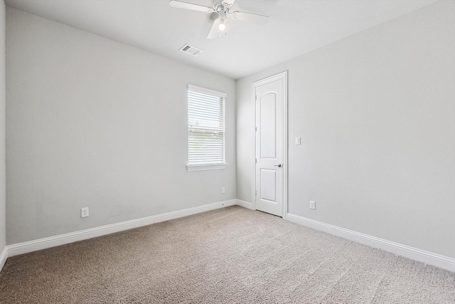 carpeted spare room featuring ceiling fan