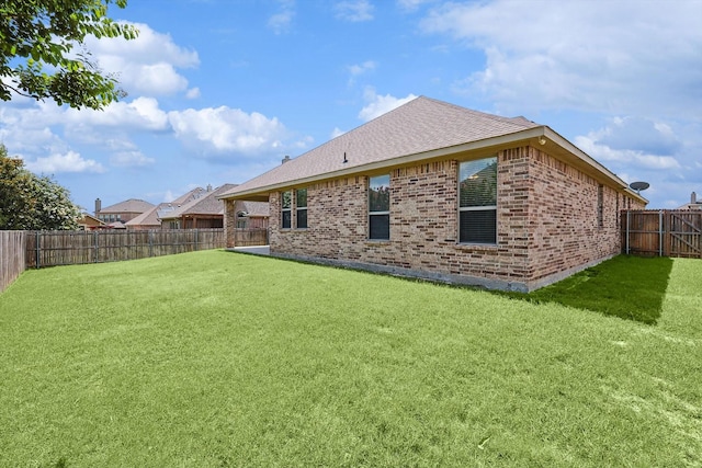 rear view of property with a lawn