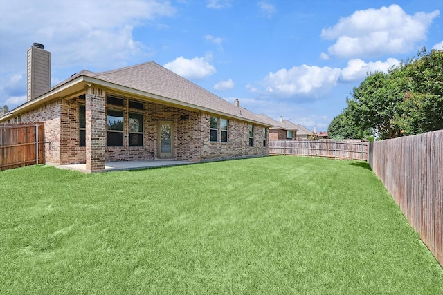 rear view of property with a patio area and a lawn