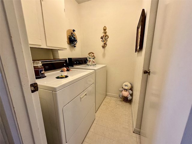 washroom featuring independent washer and dryer, cabinets, and light tile floors