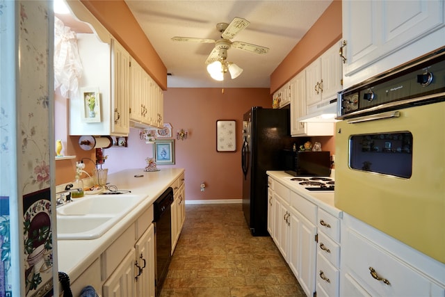 kitchen featuring ceiling fan, white cabinetry, dark tile flooring, sink, and white appliances