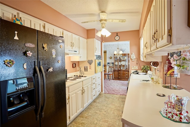 kitchen featuring white appliances, ceiling fan with notable chandelier, a textured ceiling, light tile floors, and sink