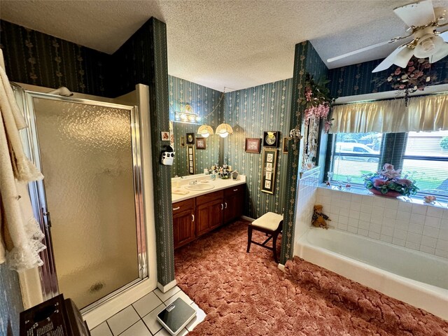 bathroom featuring a textured ceiling, plus walk in shower, vanity, and ceiling fan