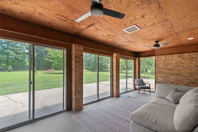 unfurnished sunroom featuring ceiling fan and wooden ceiling