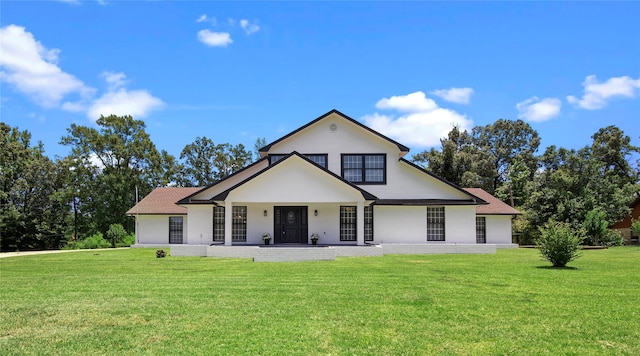 view of front of house with covered porch and a front yard