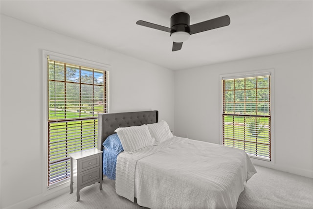 bedroom featuring ceiling fan and light carpet