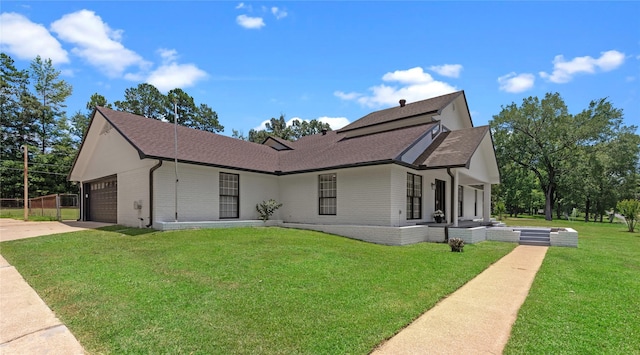 view of front of home with a front yard and a garage