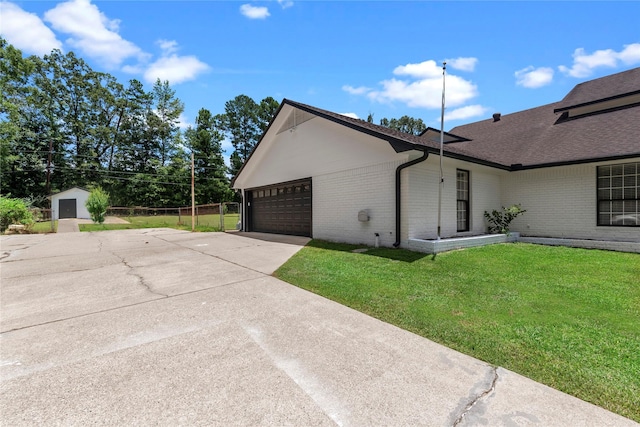 view of home's exterior with a yard and a garage