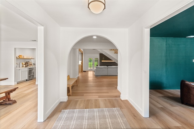 hallway with light hardwood / wood-style floors