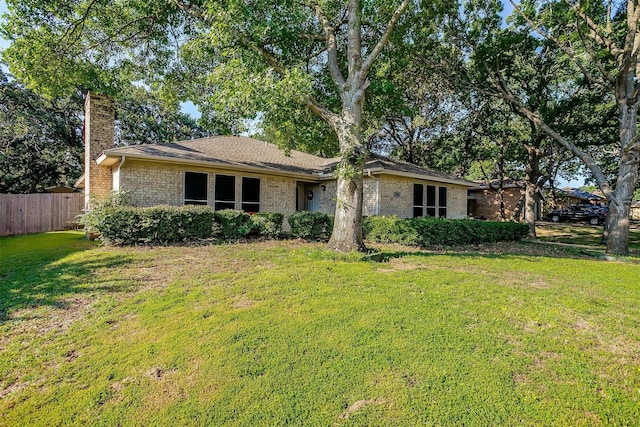 ranch-style home featuring a front yard