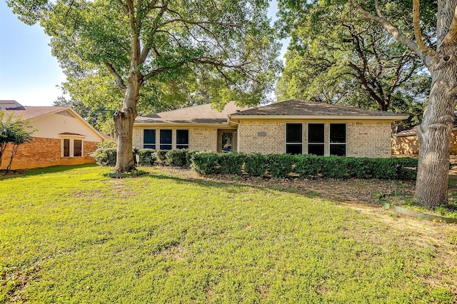 ranch-style home featuring a front yard