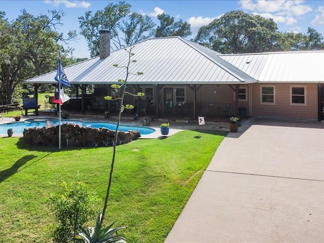 exterior space with a patio area and a lawn