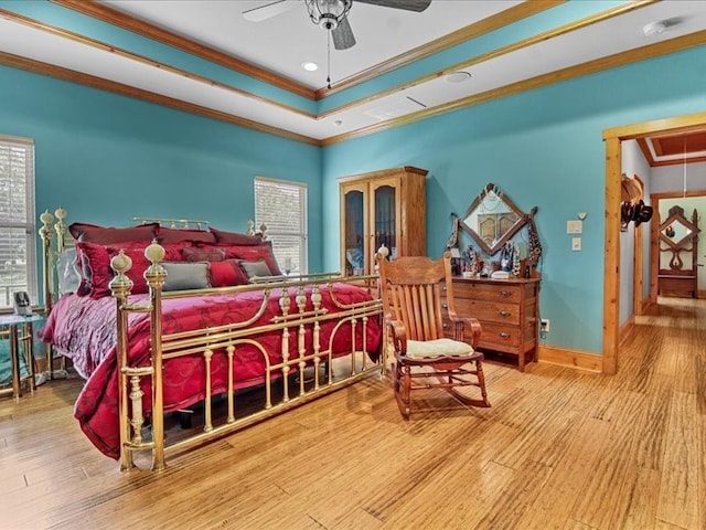 bedroom featuring hardwood / wood-style floors, ornamental molding, and ceiling fan