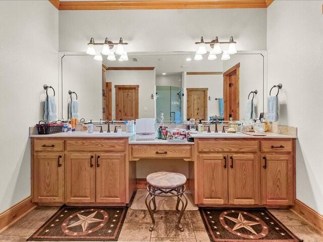 bathroom featuring dual sinks, tile flooring, vanity with extensive cabinet space, and crown molding