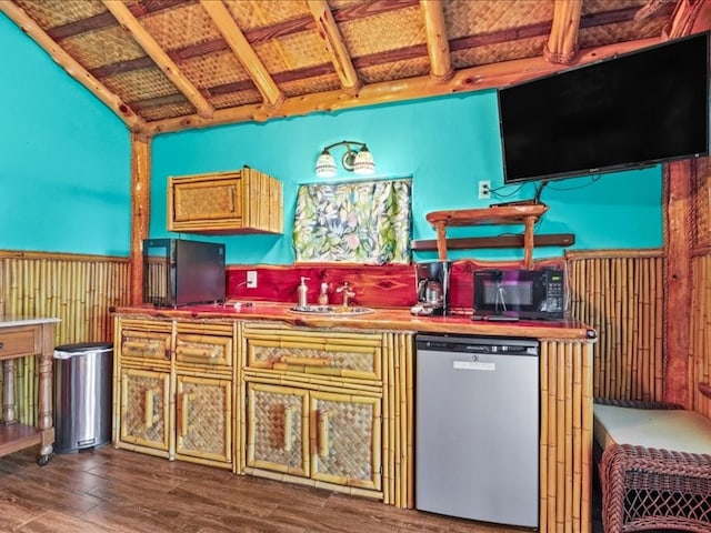 kitchen featuring hardwood / wood-style floors, sink, and stainless steel dishwasher