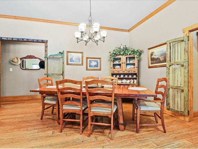 dining space with a notable chandelier, ornamental molding, and light wood-type flooring