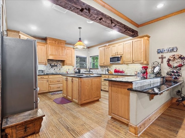 kitchen with a kitchen island, light hardwood / wood-style flooring, appliances with stainless steel finishes, pendant lighting, and tasteful backsplash