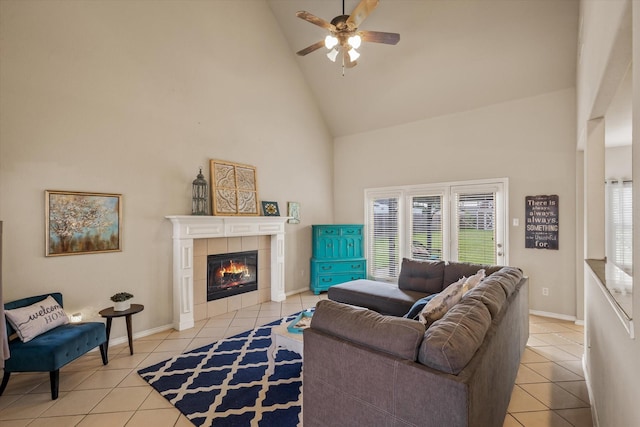 tiled living room with high vaulted ceiling, a fireplace, and ceiling fan