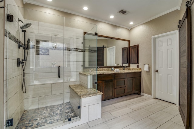 bathroom with vanity, an enclosed shower, and ornamental molding