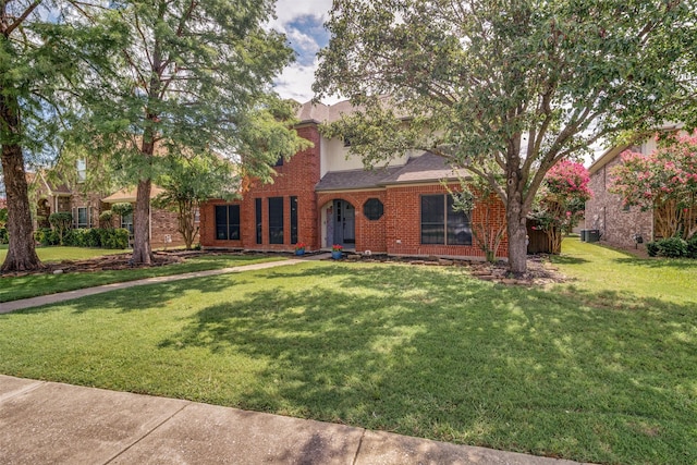 view of front of house featuring brick siding and a front yard
