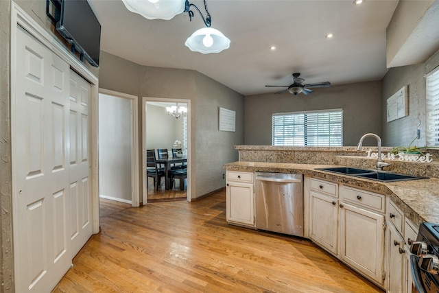 kitchen featuring sink, light hardwood / wood-style floors, decorative light fixtures, ceiling fan with notable chandelier, and appliances with stainless steel finishes