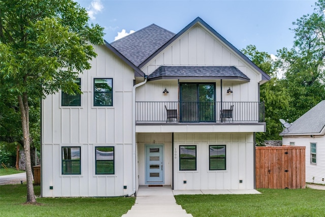 modern farmhouse with a balcony and a front yard