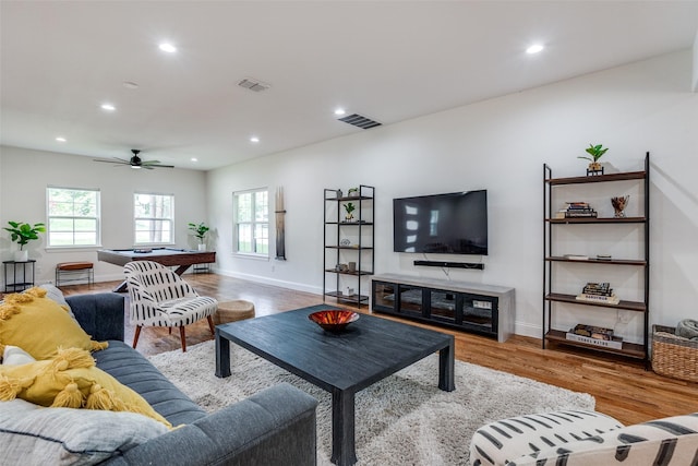 living room featuring light wood-type flooring, ceiling fan, and billiards