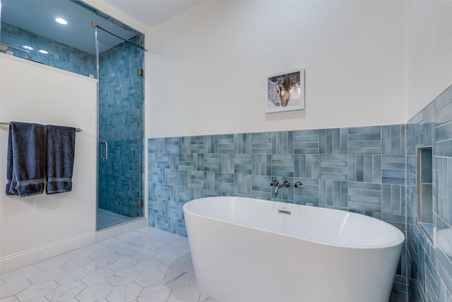 bathroom featuring separate shower and tub, tile patterned flooring, and tile walls