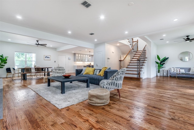 living room featuring ceiling fan and hardwood / wood-style flooring