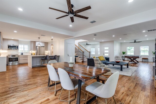 rec room with ceiling fan, pool table, and light wood-type flooring