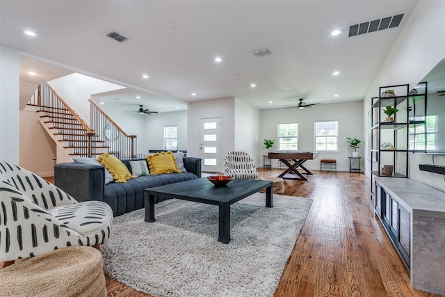 living room with hardwood / wood-style floors and ceiling fan