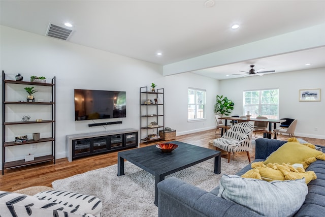 living room featuring ceiling fan and light hardwood / wood-style floors