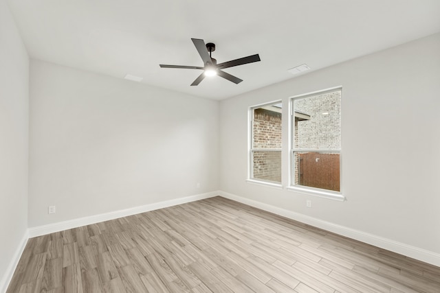 spare room featuring light hardwood / wood-style flooring and ceiling fan