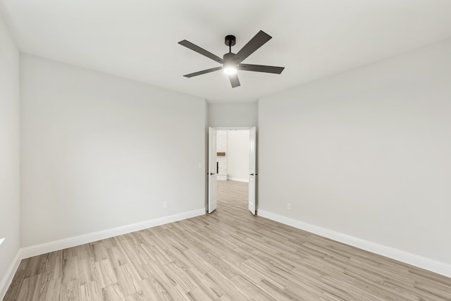 empty room featuring ceiling fan and light hardwood / wood-style floors